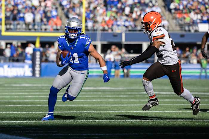 Seattle Seahawks wide receiver Jaxon Smith-Njigba (11) carries the ball after a catch while chased by Cleveland Browns safety Grant Delpit (22) at Lumen Field.